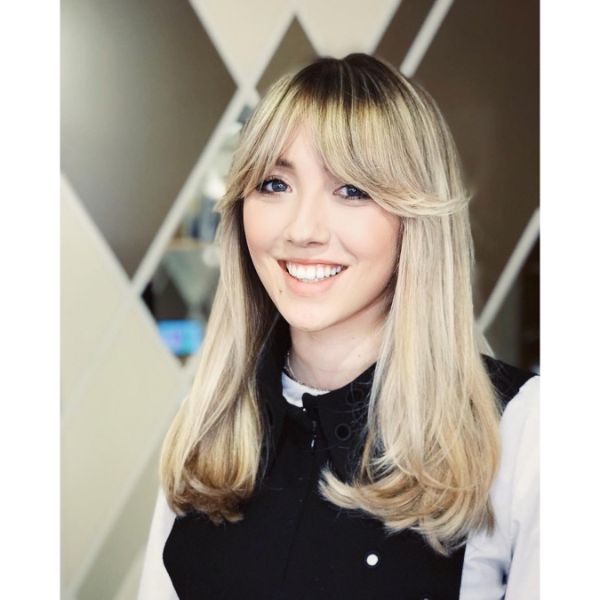 Subtle Wavy Long Layered Hairstyle with Dark Roots and Side Swept Bangs