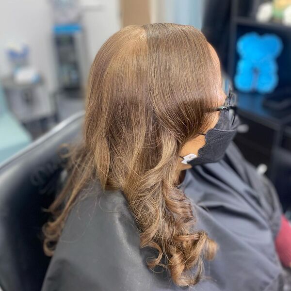 Silk Press Weave - A woman with eyeglasses wearing a black cape