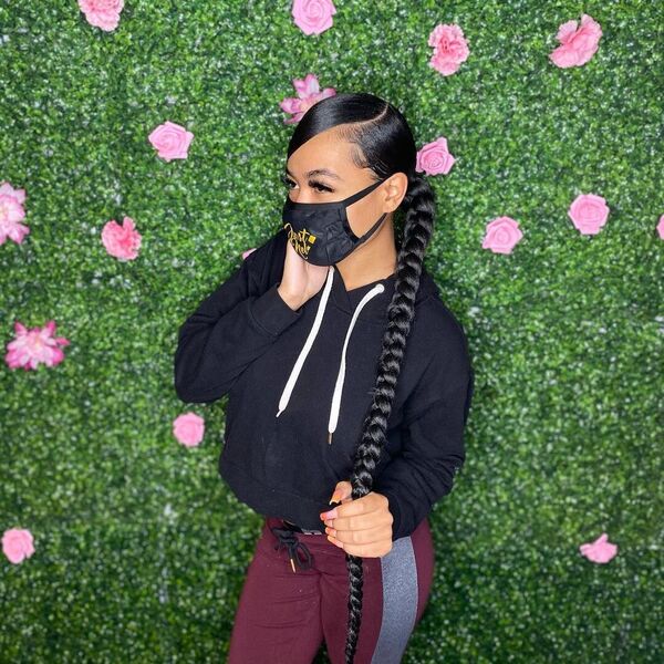 Swoop Braid Ponytail - A woman wearing a black crop top jacket