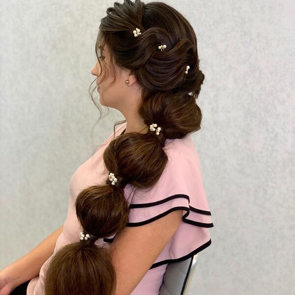 Classic Ponytail with Bubbles and Accessories - A woman wearing a pink blouse