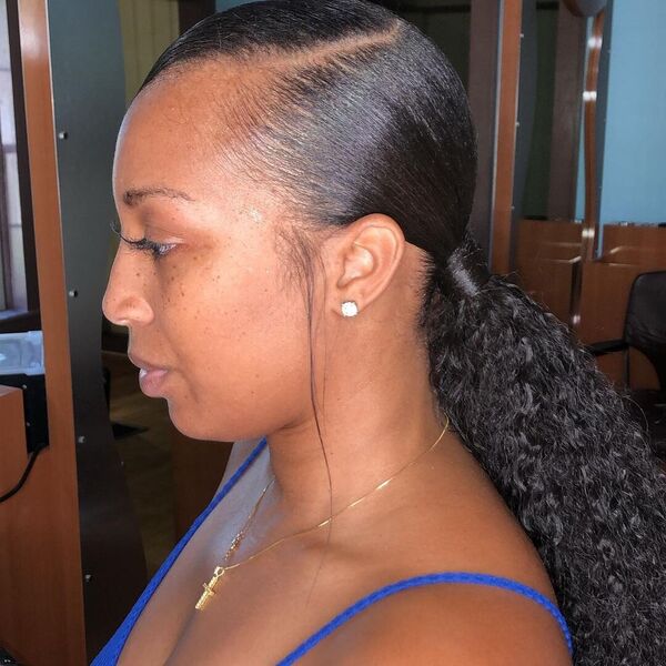 Curly and Wrap Low Ponytail - A woman wearing a earrings