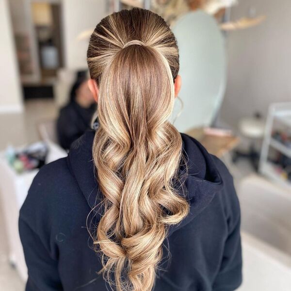 Formal Look with Low Ponytail - A woman wearing a black hooded jacket