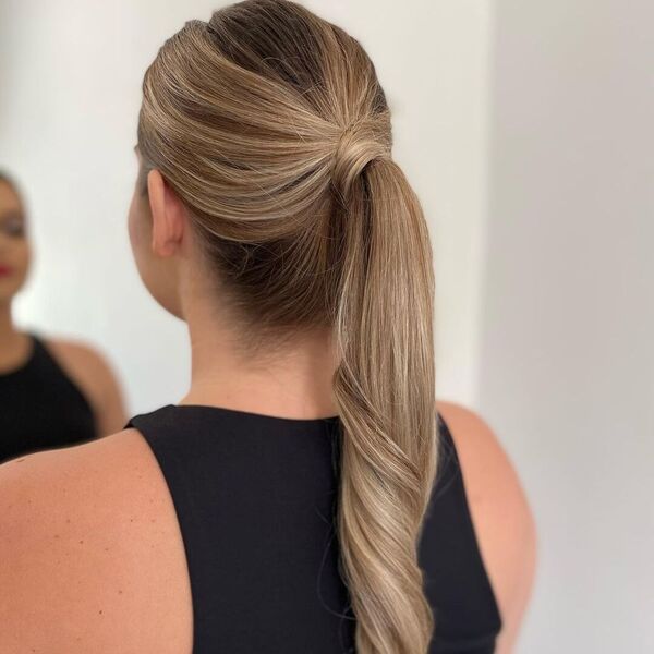 Glamour and Classic Ponytail - A woman wearing a black sexy top