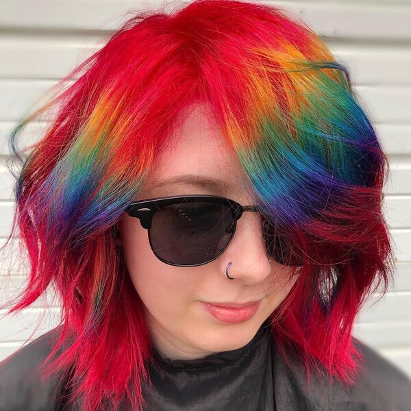 Layered Short Hair - A woman with sunglasses wearing a black cape