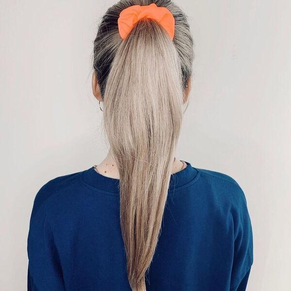 Long Hairdos Wavy at the End - A woman wearing a blue longsleeve