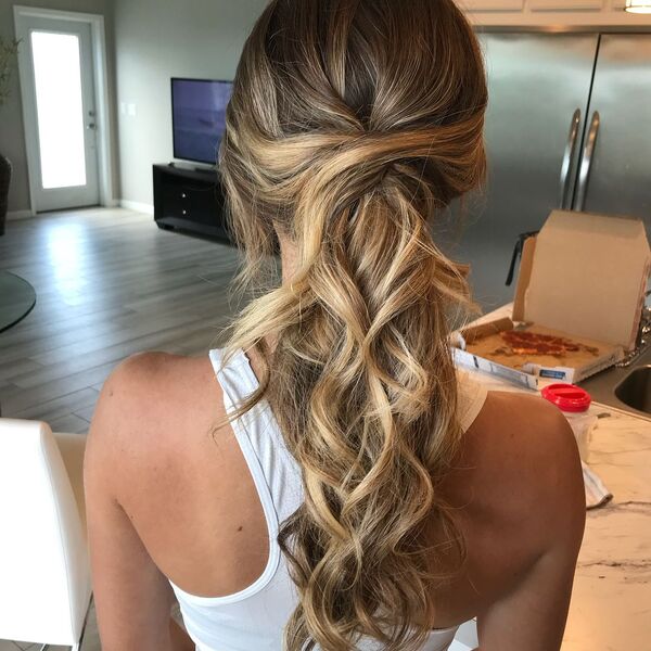 Messy and Curly Ponytail with Blonde - A woman wearing a white sexy top