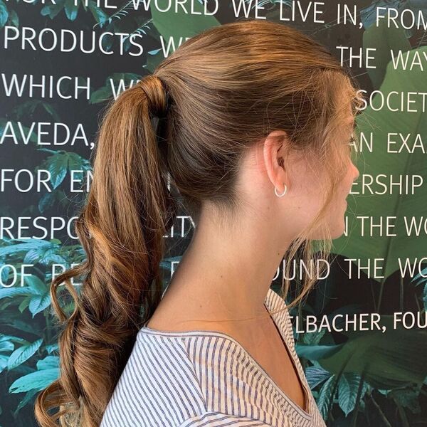Simple and Classic Ponytail - A woman wearing a stripe blouse