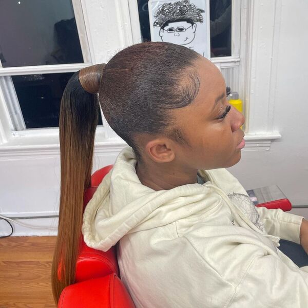 Sleek Back Mid Ponytail - A woman wearing a cream hooded jacket