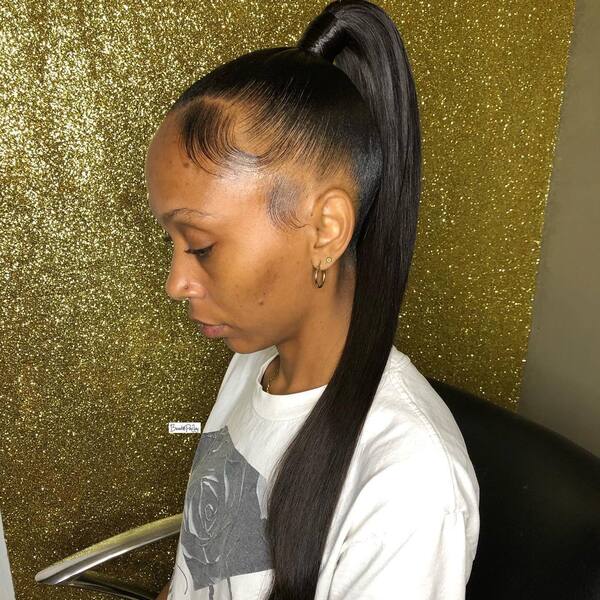 Sleek Ponytail - A woman wearing a white shirt