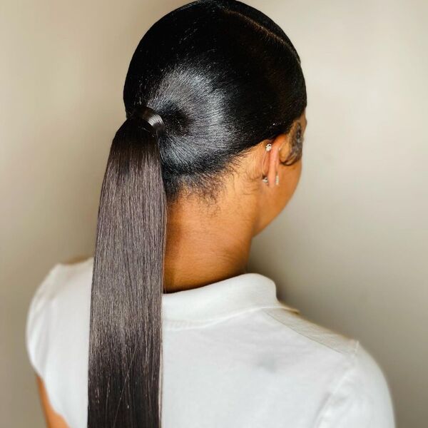 Soft and Classic Ponytail - A woman wearing a white polo shirt