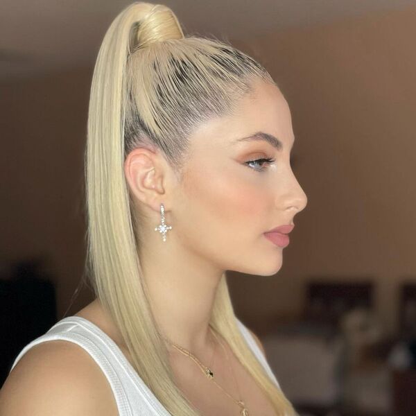 Top Ponytail with Blonde - A woman wearing a white sleeveless shirt